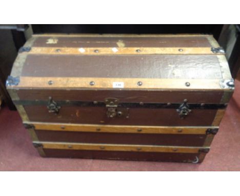 An 82cm old wood bound canvas weather coated dome-top travelling trunk with flanking iron drop handles - internal tray missin