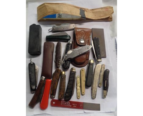 A plastic crate containing a collection of vintage and other penknives, leather sheath, sharpening stones, etc.