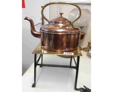 A vintage copper kettle with brass handle - sold with a brass and wrought iron trivet