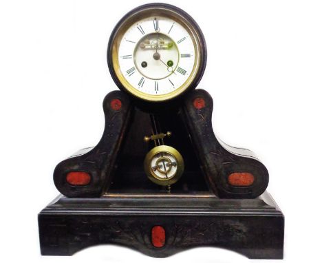A late Victorian black slate and red marble cased ornate drum and bracket base mantel clock with visible escapement, shaped b