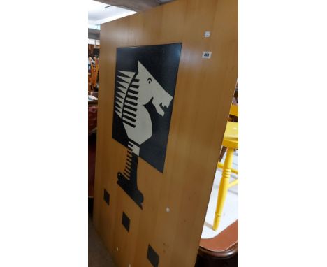 A large wooden trade sign with inset decorative polished stone chess motif