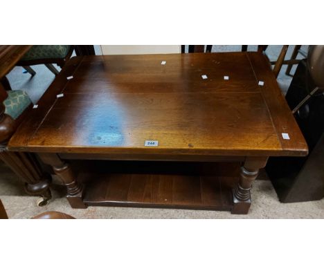 A 90cm vintage polished oak coffee table, set on turned supports with undertier