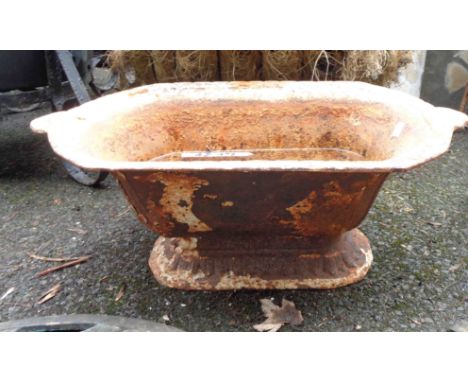 A 60cm antique cast iron low pedestal planter