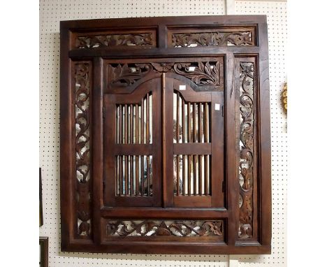 An eastern stained wood framed 'window' wall mirror with decorative fretwork panelled border and pair of stick set doors to f