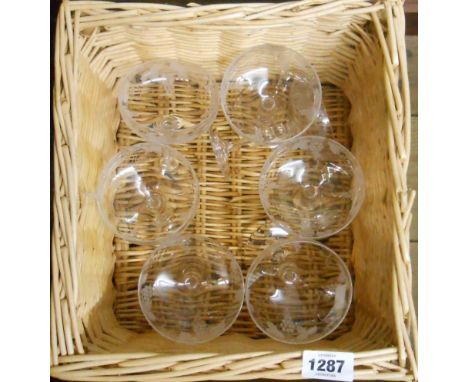 A basket containing seven vintage Champagne coupes with engraved grape and vine decoration