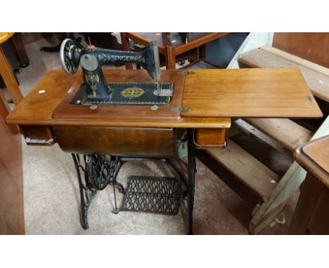 A 90cm vintage Singer sewing machine, set on a cast iron treadle base