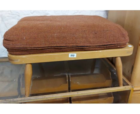 A light Ercol footstool with upholstered cushion, set on tapered legs