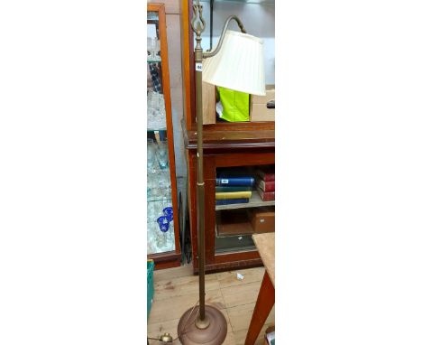 A vintage brass standard lamp, set on circular base - with shade