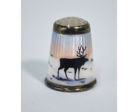 A Norwegian silver and enamel thimble in the manner of Aksel Holmsen, decorated with a reindeer stag in a winter landscape, m
