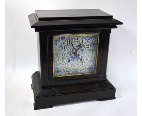 A Victorian Aesthetic movement ebonised mantle clock of architectural form, the eight-day movement with floral-painted cerami