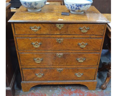 An 18th century and later walnut veneered chest of four long graduated drawers on shaped bracket feet, repairs/alterations, 8