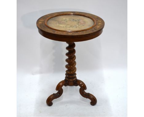 A 19th century floral marquetry walnut tripod table, the circular tilt top inset with a glazed petit point panel raised on a 