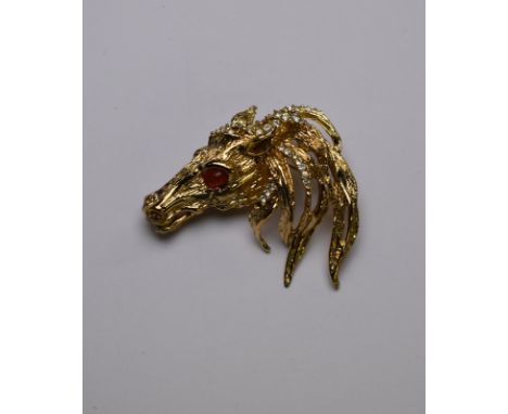 Christian Dior - A gilt metal horse head statement brooch, with flowing mane set with white stones and stone set eyes, stampe