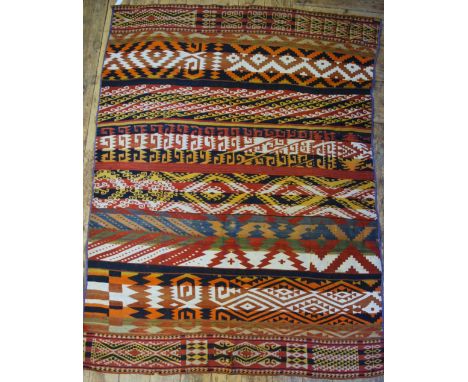 An antique Caucasian kelim Sumak weave fragment in panels, 19th century, the stripes design in alternating colours, 2.20 x 1.