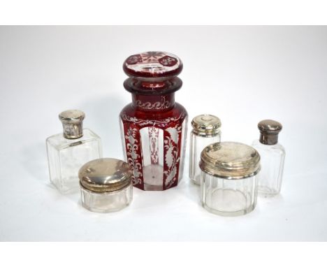 A French cut glass scent bottle with 950 grade silver collar and screw cover, to/w three cut glass toilet jars with silver to