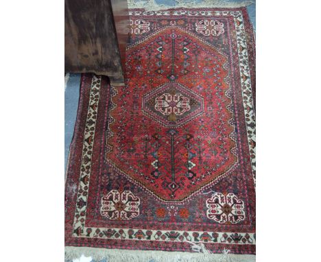 An old Persian Hamadan rug, circa 1920's, the red ground centred by a medallion, 1.48 x .95 m Condition Report good even pile