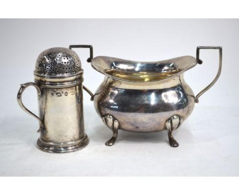A Victorian silver sugar caster in the form of a flour dredger with scroll handle, Nathan & Hayes, Birmingham 1894, 10cm high