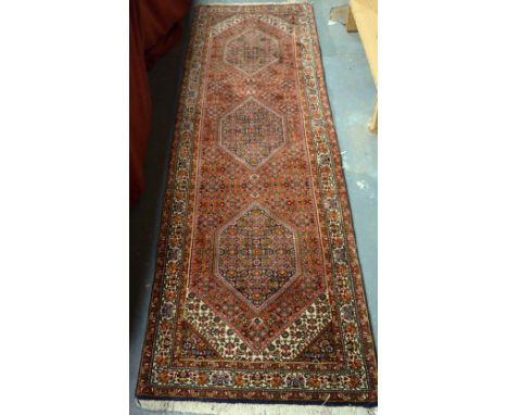 A Persian Bidjar runner, triple lozenge design on rust ground, 2.42 x .73  m - with receipt and certificates of origin