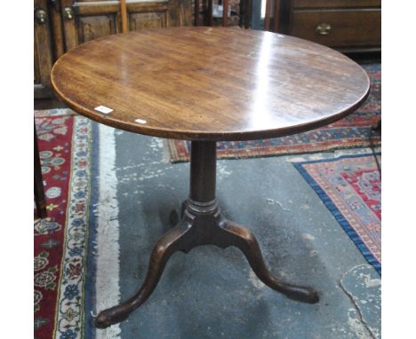 An 18th century circular tilt top oak tripod table with turned support to pad foot legs, 82 cm dia x 71 cm high