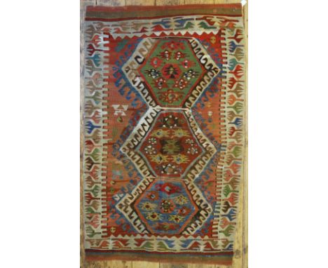 A 19th century Anatolian kelim, the triple lozenge design on pale multi-coloured ground, 152 x 0.92 m Condition Report areas 