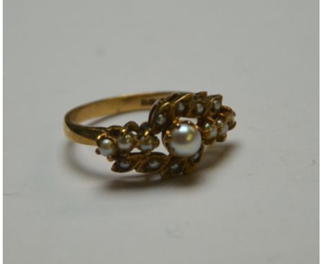 An Edwardian style half pearl set cluster ring, 9ct yellow gold claw setting