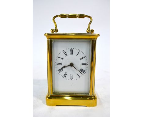 A brass carriage clock, the single train movement with white enamelled dial, in travel case, 10 cm high