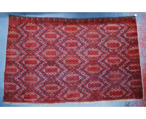 A Turkmen Tekke bag face, 19th century, traditional design of repeating geometric lozenges on red ground, 1.63 x 1.02 m Condi