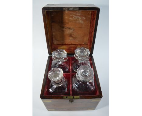 A 19th century brass-bound rosewood decanter box, the velvet and leather-lined interior fitted with three square cut glass de