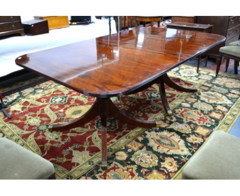 A good quality Victorian style mahogany twin pedestal dining table, raised on outsplay moulded legs to brass caps and castors