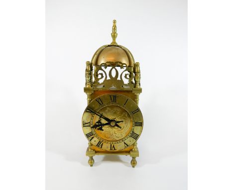 A brass lantern clock, height 26cms, currently working 