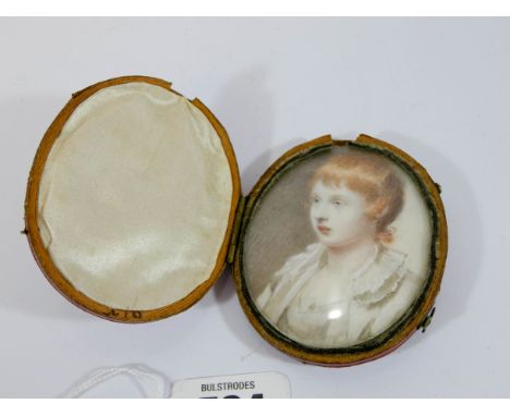 19th century portrait miniature depicting a red headed child, on ivory, beneath glazing within red leather folding frame. 7.5