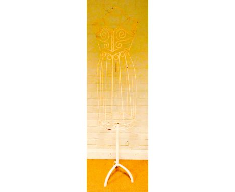 A cream painted metal dress makers stand on a tripod base 