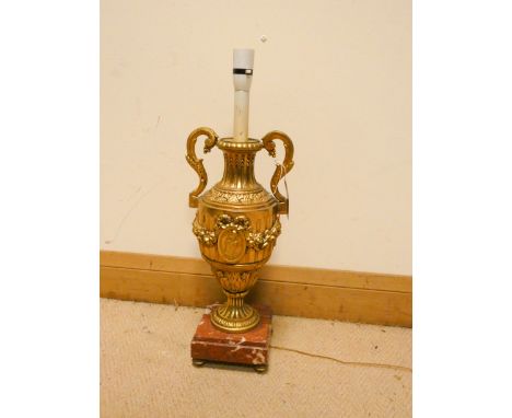 A French gilt metal urn shaped table lamp on a red marble base 