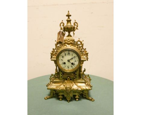 A French striking mantle clock in heavy decorative brass case with enamel dial, 17 1/2" high   No pendulum 