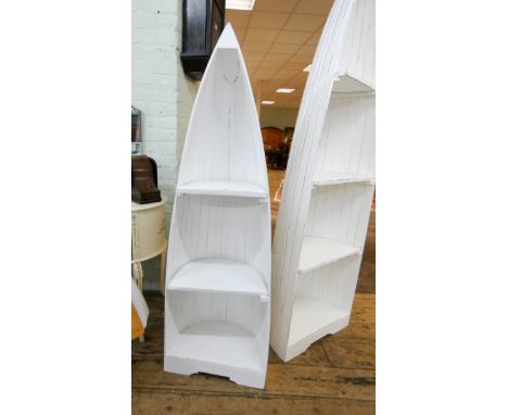 A smaller white painted two shelf boat shaped open bookcase 57" tall 