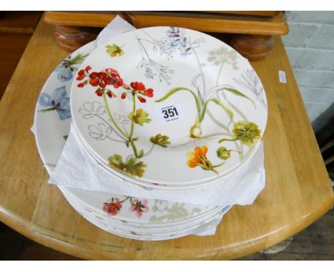 Ten matching Poole Pottery floral decorated dinner plates and six matching tea plates 
