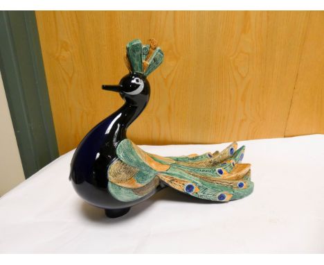A Goebel model of a peacock, the tail signed Selim, numbered on base 3894028, height 28cms