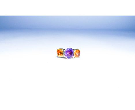 Ladies statement three stone dress ring, set with citrines and amethyst in closed back settings, on yellow metal band. Ring s