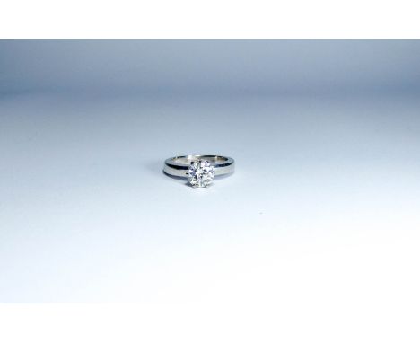 solitaire diamond ring set with a circular brilliant cut diamond, weight 1.36 carats, in raised claw setting on hallmarked 18