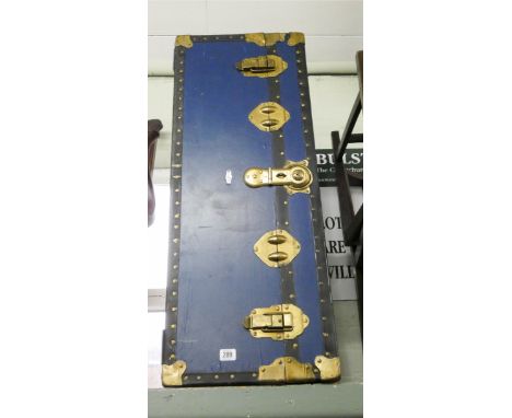 A blue metal bound cabin trunk 