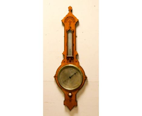 An Edwardian Arts and Crafts style barometer in carved light oak case by Negretti and Zambra 