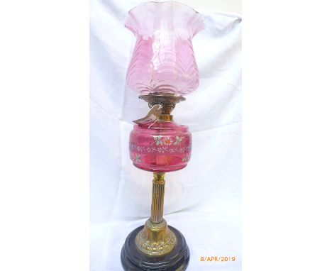 Victorian oil lamp with brass corinthian column on circular ebonised plinth, decorative cranberry glass shade and bowl with r