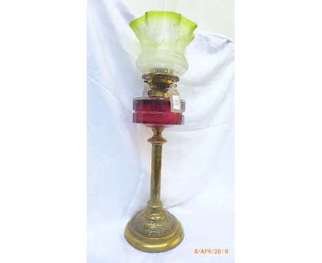 Brass circular based Victorian oil lamp with dark cranberry glass bowl and etched part green glass shade