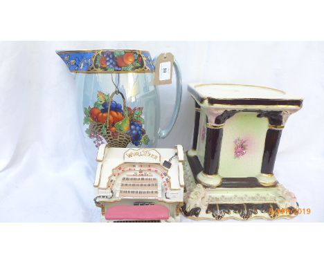 Decorative light blue brown water jug, a Blackpool Tower Wurlitzer ballroom organ ornament and a mantelpiece pedestal.