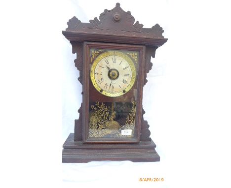American mantel clock ex. Seth Thomas with brass pendulum in carved hooded case