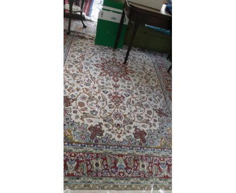 Multi coloured floral patterned blue beige and red ground tasselled carpet (115" x 80")