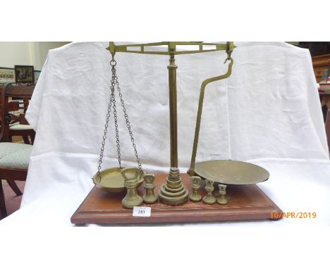 Set of Avery balanced pan scales with bell shaped and other brass weights