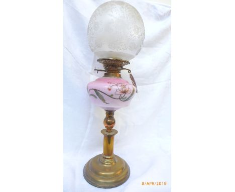 Brass circular based early 20th century oil lamp with floral patterned pink bowl and etched domed shade