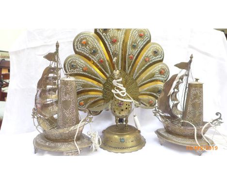 Pair of metal sailing ship lamps and a brass peacock table lamp 