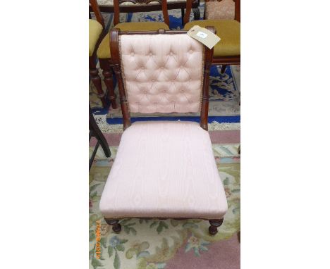 Low mahogany framed button backed Edwardian occasional chair on pot casters, the padded back and seat upholstered in pink sat